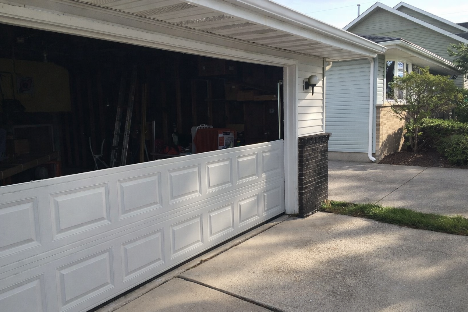 Garage door with missing panel needing replacement